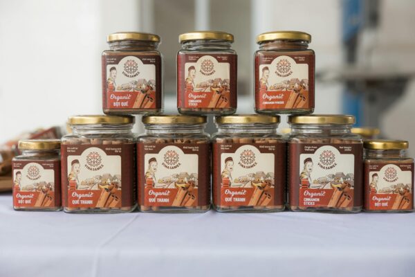 Organized display of organic cinnamon jars in glass containers on a table.